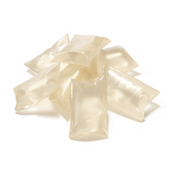 Clear, light-colored hot melt adhesive pillows of H.B. Fuller HL-2916-PW designed for removable applications like mailers and inserts.