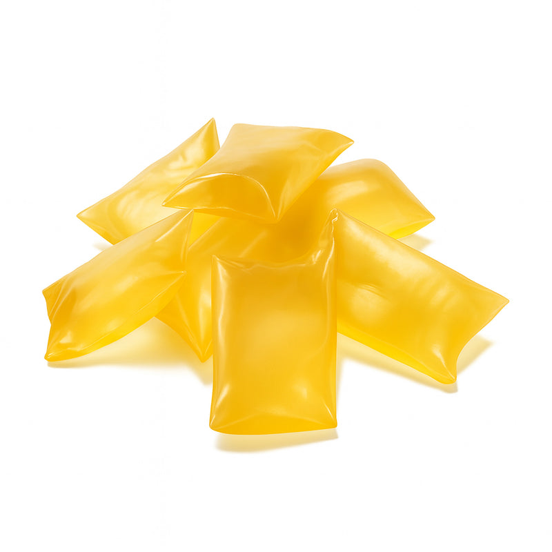 Light yellow/amber hot melt adhesive pillows – H.B. Fuller HM-1669 low-viscosity labeling adhesive for PET, plastic, and glass containers.