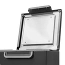 Open lid of Meler Micron+ hot melt adhesive melter showing insulated tank cover and heated interior access panel.