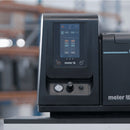 Front view of Meler Micron+ adhesive melter with touchscreen control panel, pressure gauge, and operator controls.