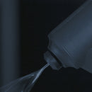 Hot melt adhesive being dispensed from Meler spray gun nozzle showing consistent flow and application control