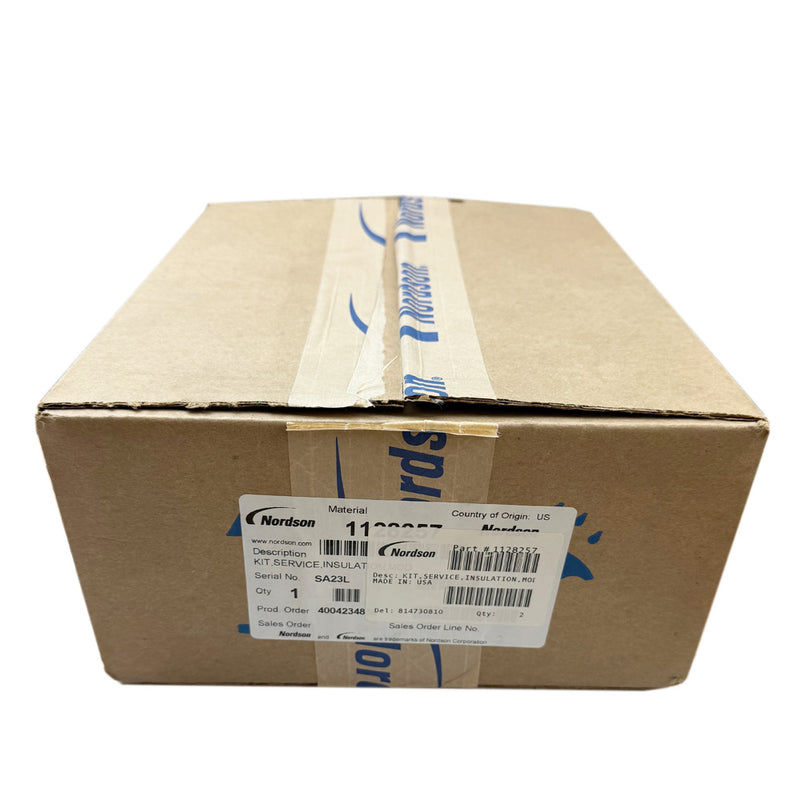 Cardboard box labeled with Nordson 1128257 part number, showing product and shipping information