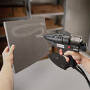 Hot melt spray adhesive being dispensed from a Power Adhesives 6300 glue gun onto a foam panel for packaging or fabrication use.