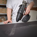 Power Adhesives spray glue gun applying hot melt adhesive evenly onto a flat substrate for packaging assembly.