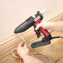 Tec 806 hot glue gun applying controlled adhesive bead for flooring, trim, and light woodworking jobs