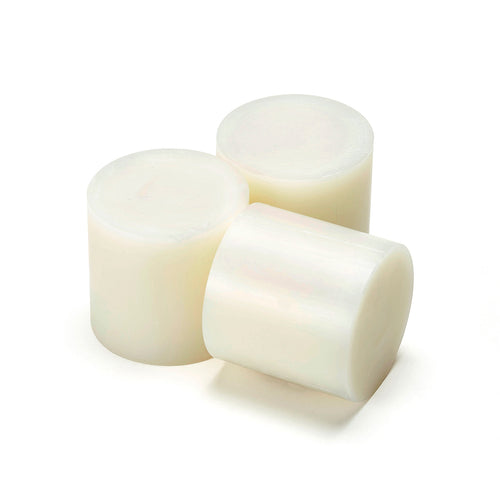 Foundrytec 104 hot melt glue slugs shown in pale amber, used for sand core bonding in foundry applications.
