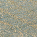 Macro view of hot melt adhesive spray pattern on foam, highlighting uniform application lines.