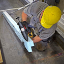 Applying hot melt adhesive to a large construction material using the Power Adhesives Tec 3508 cordless glue gun on a jobsite.