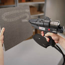 Hot melt adhesive is sprayed evenly onto a work surface with the Tec 6300, demonstrating controlled pneumatic application.
