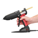 The Tec 830 hot melt gun held in one hand, highlighting grip comfort and trigger control