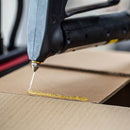 Tecbond 110B bulk hot melt adhesive applied to cardboard packaging, showing strong tack and fast set