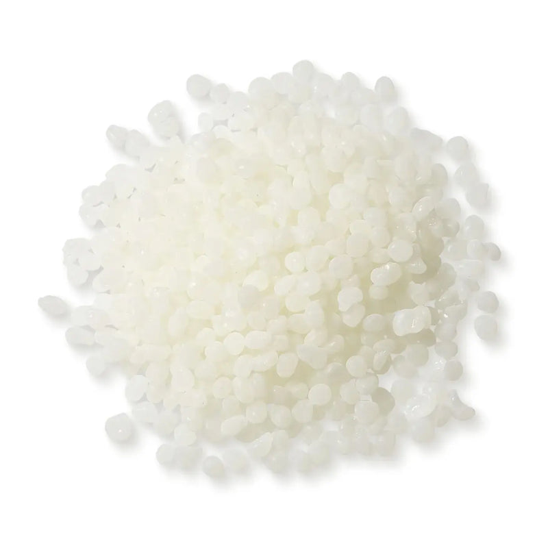Close-up of Power Adhesives Tecbond 351B biodegradable hot melt adhesive pellets, off-white in color.